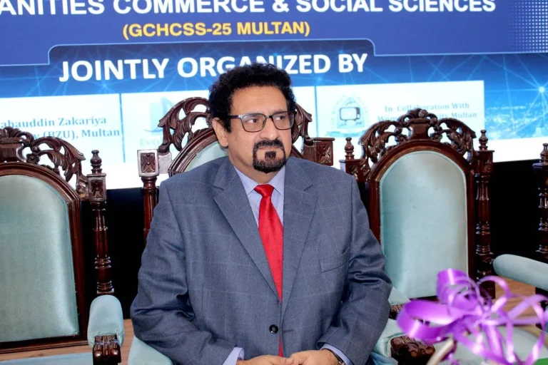 Chief guest seated on stage in front of the GCHCSS-25 backdrop in Multan