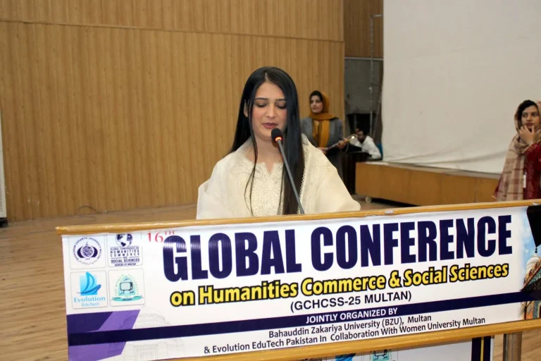 Host speaking from the GCHCSS-25 rostrum at Bahauddin Zakariya University, Multan