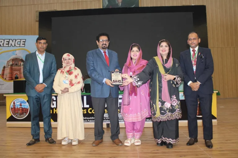 Commemorative shield presented to a guest speaker on the GCHCSS-25 stage in Multan
