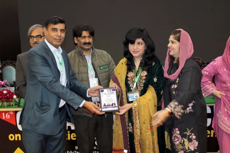 Shield presented to a researcher on stage at GCHCSS-25 in Multan