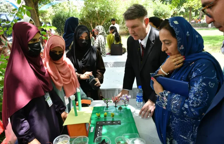 Students explaining their project model to visiting delegates at the ICELS-26 expo in Rawalpindi
