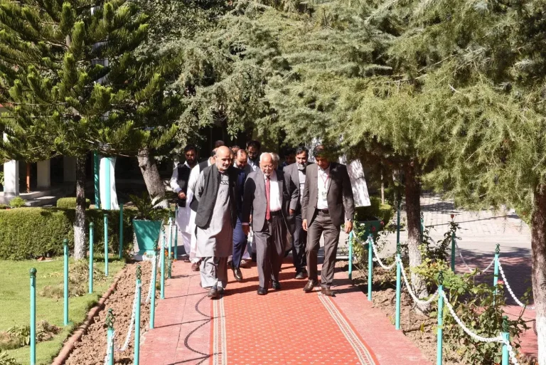 Chief guest and delegates walking through the COMSATS University Abbottabad campus gardens on the morning of ICEPSD-25