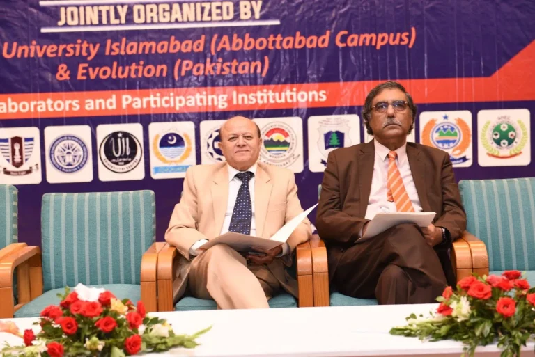 Two guests of honour seated on stage under the ICEPSD-25 banner naming COMSATS University Islamabad, Abbottabad Campus and Evolution EduTech Pakistan as joint organisers
