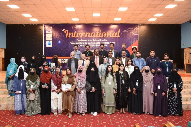 Participants, faculty and organisers group photo on stage at the close of ICEPSD-25 in Abbottabad
