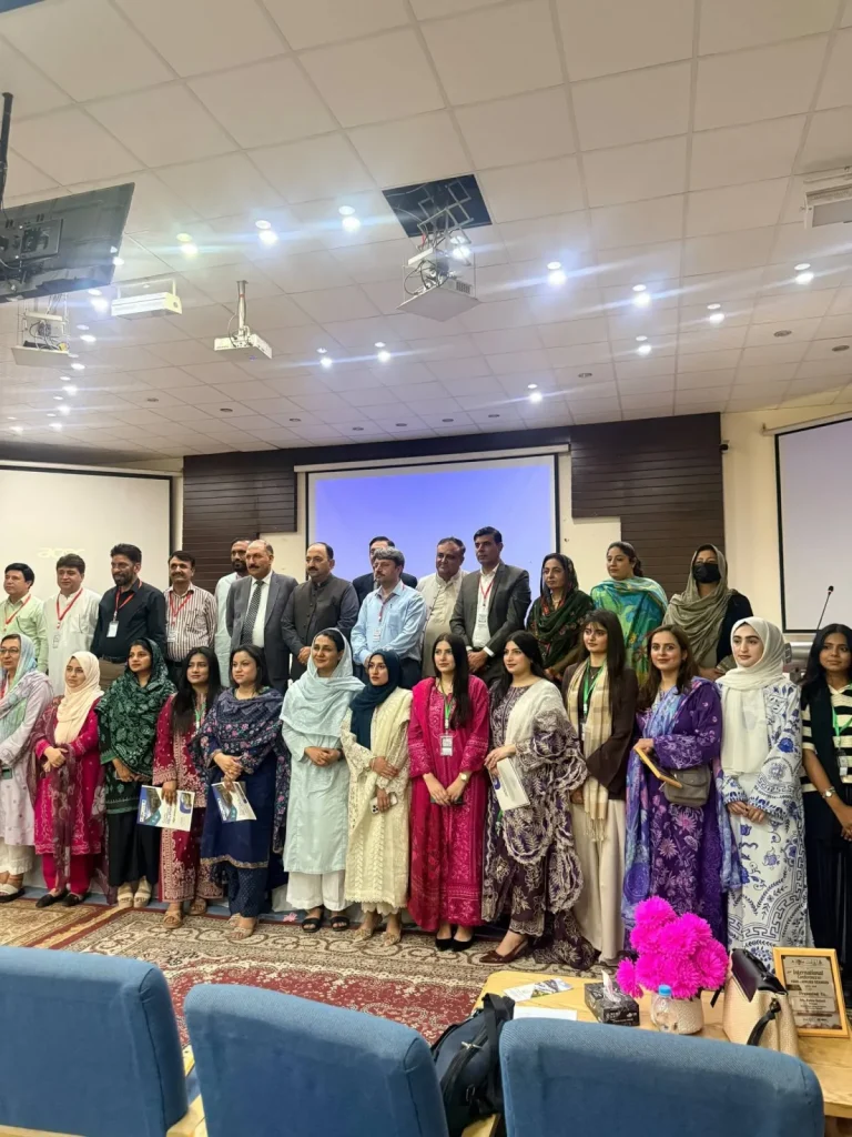 Delegates and faculty group photo in the conference hall at ICFAS-26, Karakoram International University, Gilgit