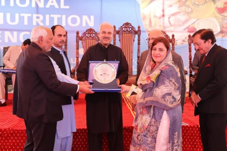 Shield presented to a woman delegate at the International Food & Nutrition Conference 2022 in Swat